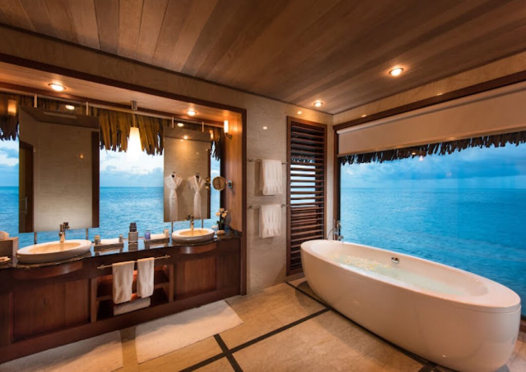 Luxurious Bathroom Interior of an Overwater Bungalow at Le Bora Bora by Pearl Resorts, Featuring Elegant Design and Breathtaking Lagoon Views