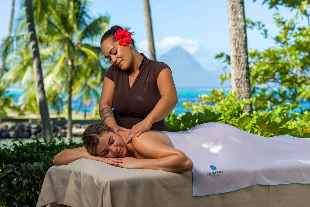 Guest Enjoying a Traditional Polynesian Massage at the Intercontinental Tahiti Resort & Spa, Surrounded by Tropical Ambiance and Serene Lagoon Views.