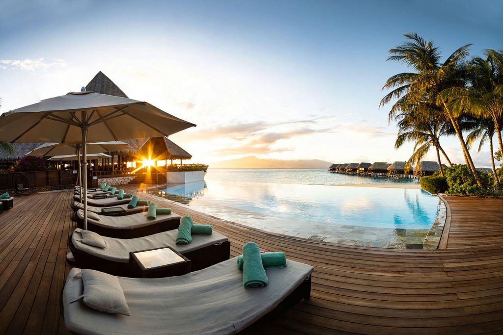 Scenic Pool View at Sofitel Kia Ora Moorea Beach Resort, Overlooking the Turquoise Lagoon and Framed by Swaying Palms and Lush Tropical Gardens.