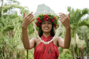 | Blue Tahiti Travel Smiling Tahitian Model Dressed in Traditional Attire Welcoming Australian Visitors with a Flower Lei, Embodying the Warm Hospitality of a Tahiti Travel Specialist.